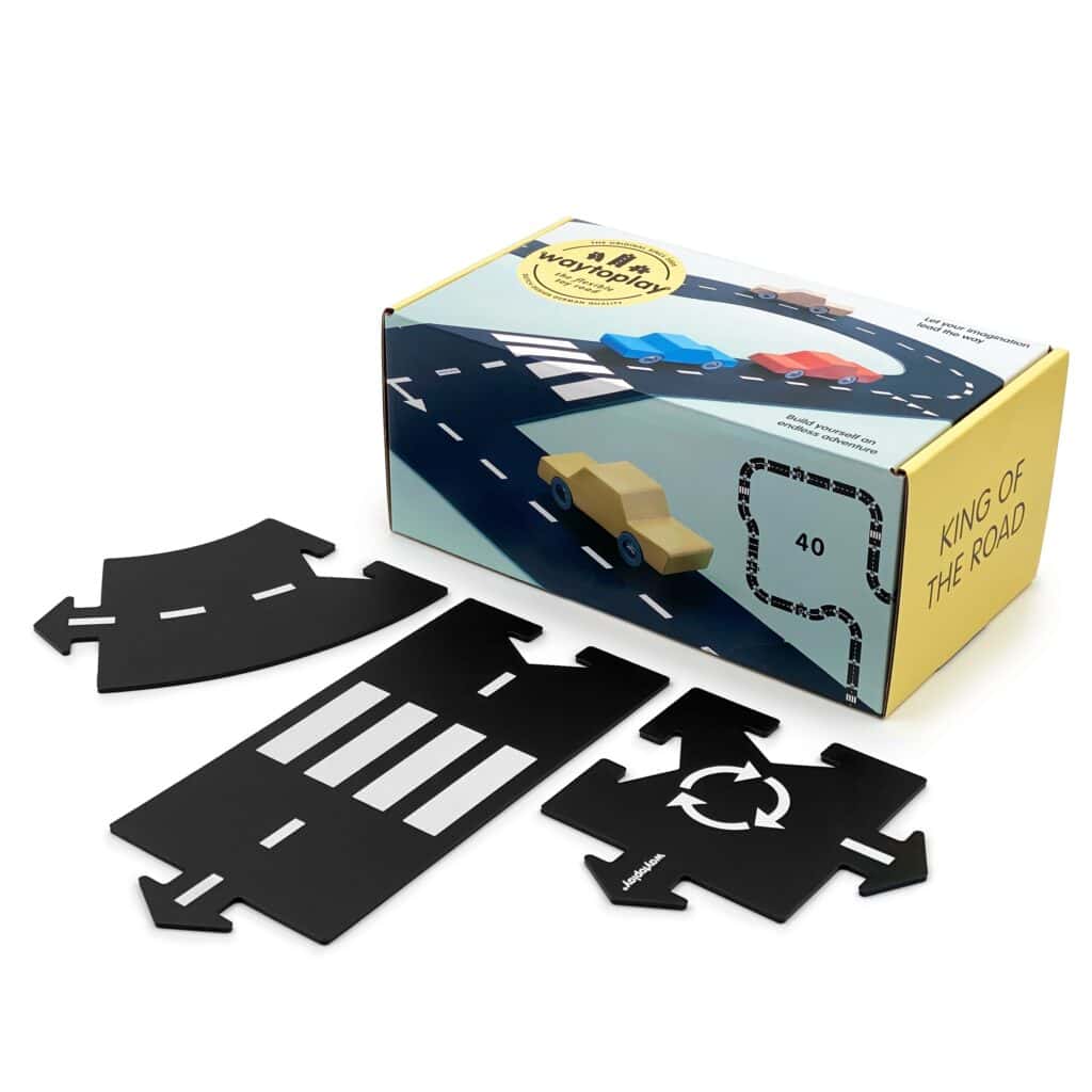 Toy road set with box and track pieces.
