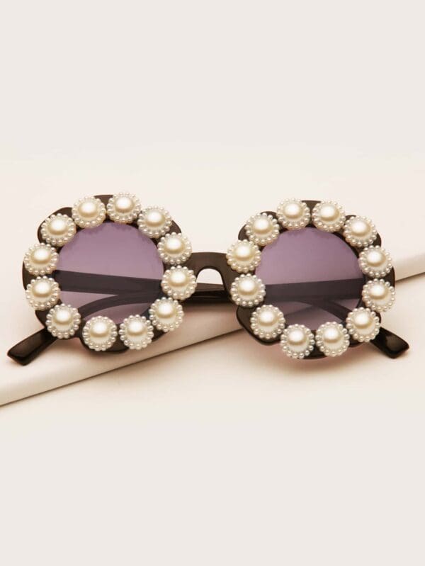 Sunglasses adorned with pearl embellishments.