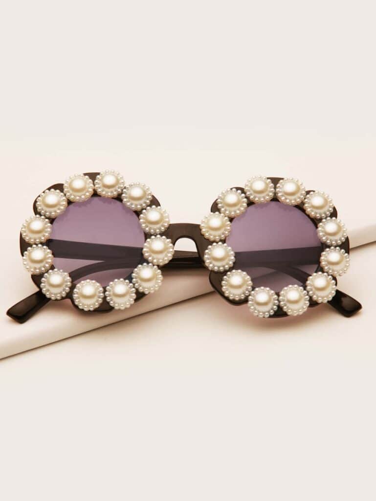 Sunglasses adorned with pearl embellishments.