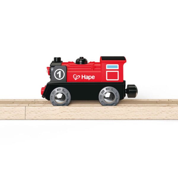 Red toy train on wooden track