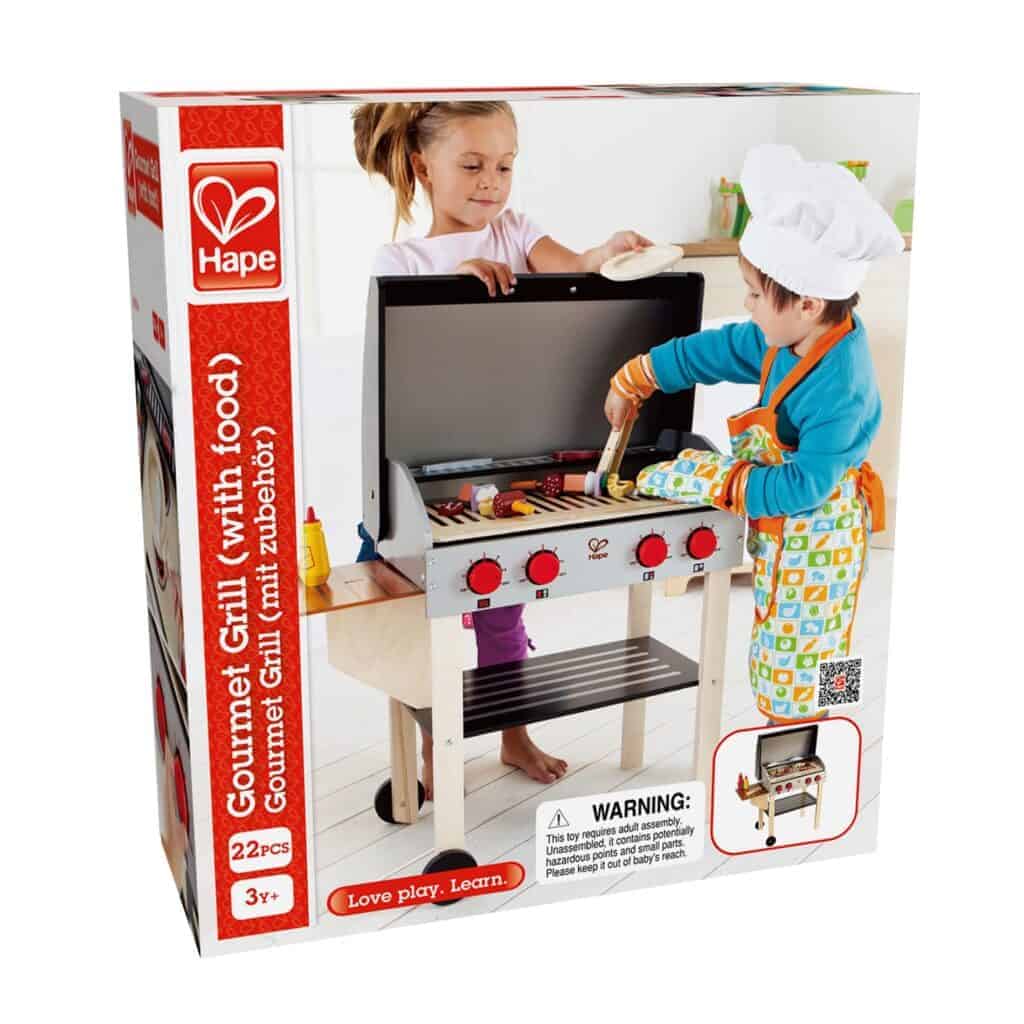 Children playing with Hape Gourmet Grill toy set.