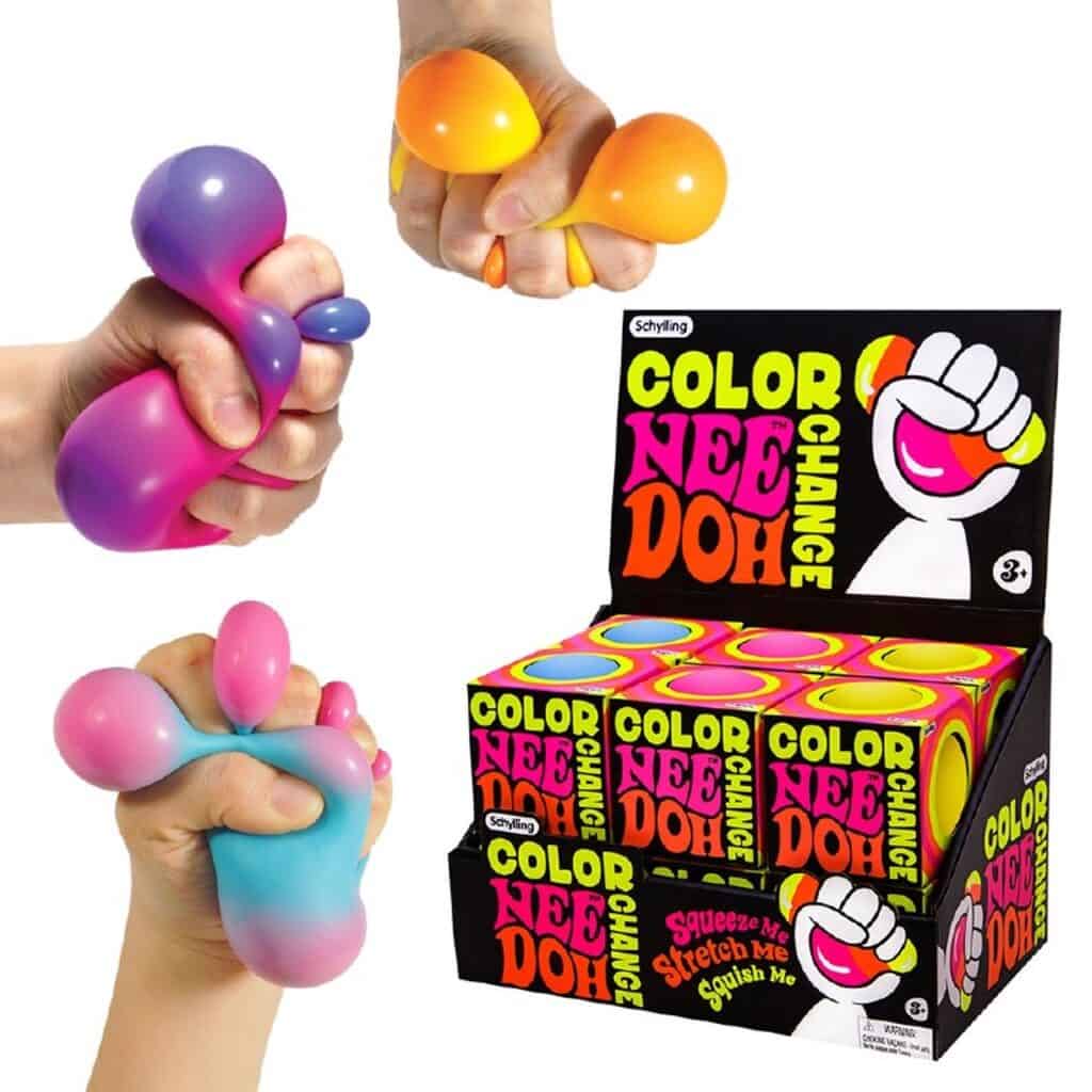 Hands squeezing colorful Nee Doh stress balls.
