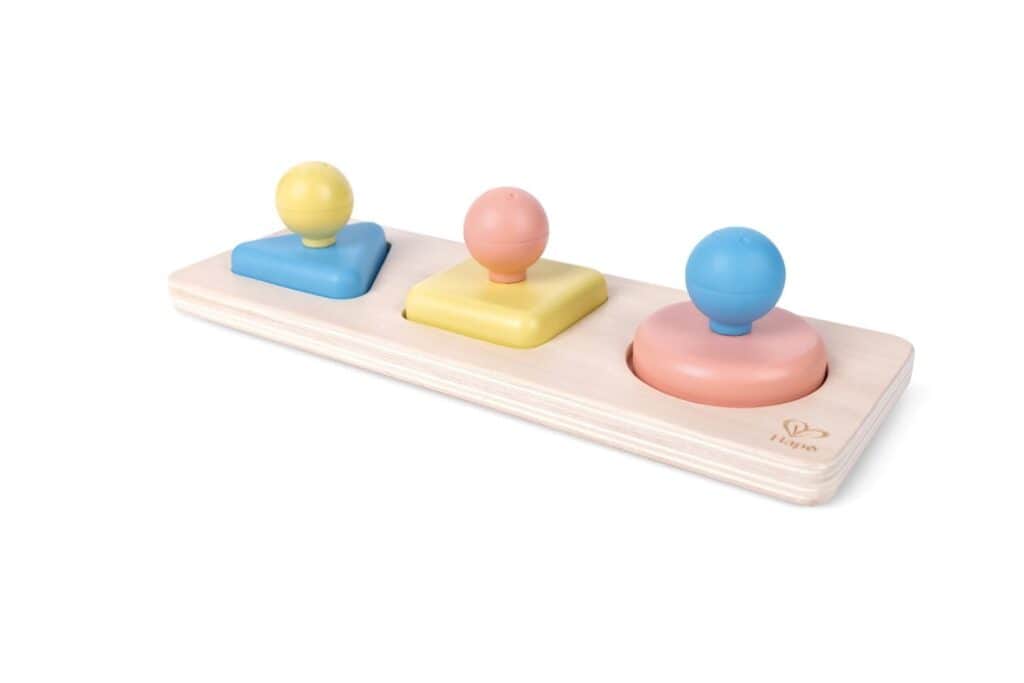 Colorful wooden shape sorter toy with pegs