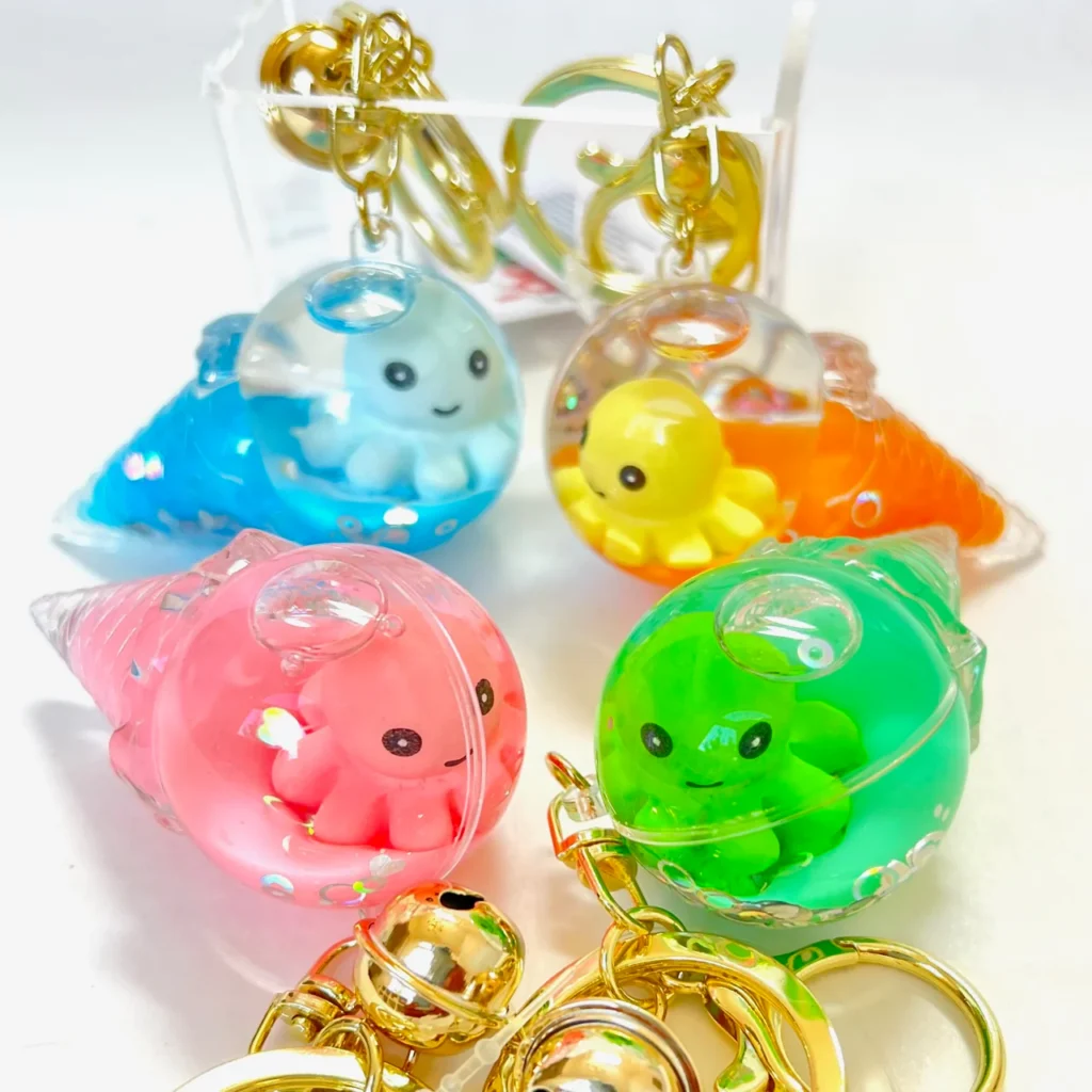Colorful octopus keychains in transparent casings.