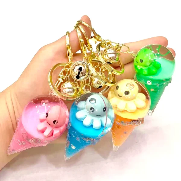 Colorful ice cream octopus keychains in hand.
