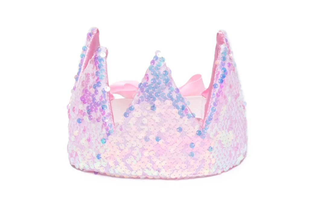 Pastel sequin crown with pink ribbon detail.