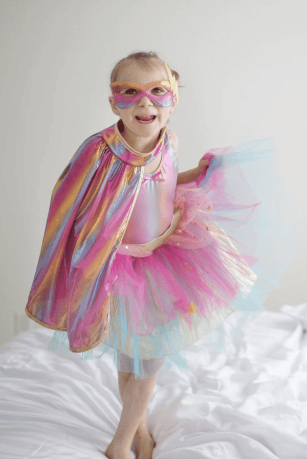 Child in colorful superhero costume smiling