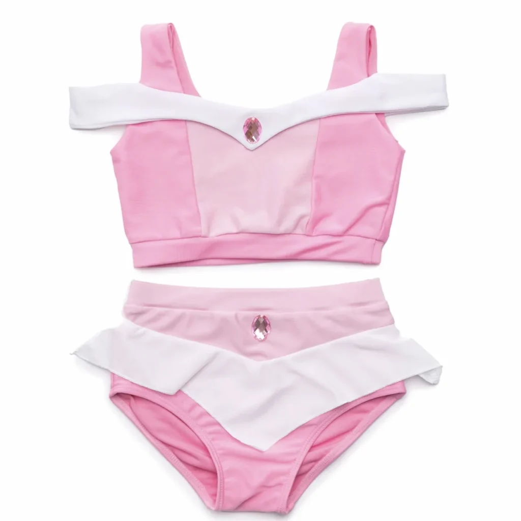 Pink and white swimsuit with gemstone accents.