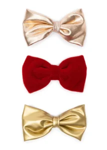 Three metallic and velvet bow ties in gold, red.