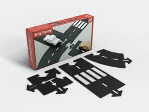 Toy road set with car and arrows.