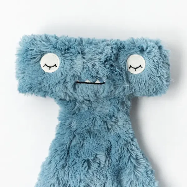 Blue fuzzy plush toy with round eyes.