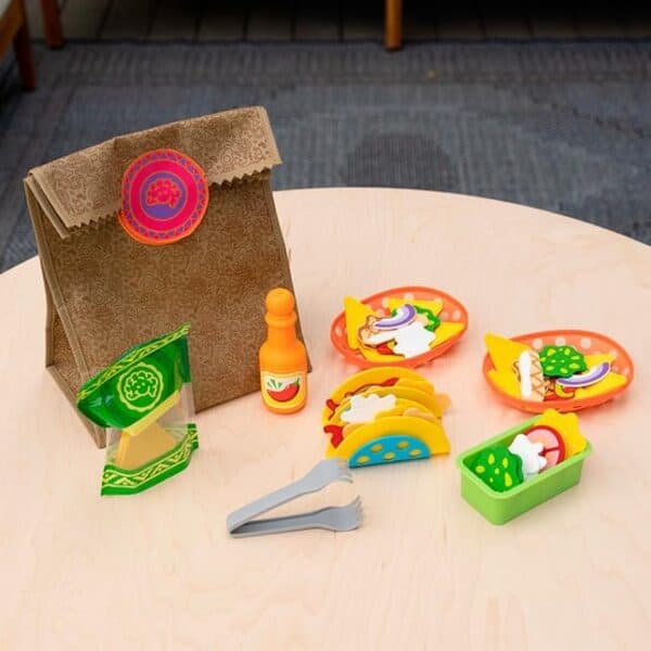Toy tacos and lunch bag on table