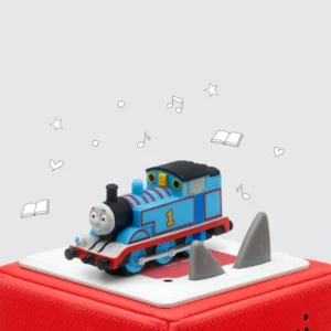 Toy train on speaker with musical notes and hearts.