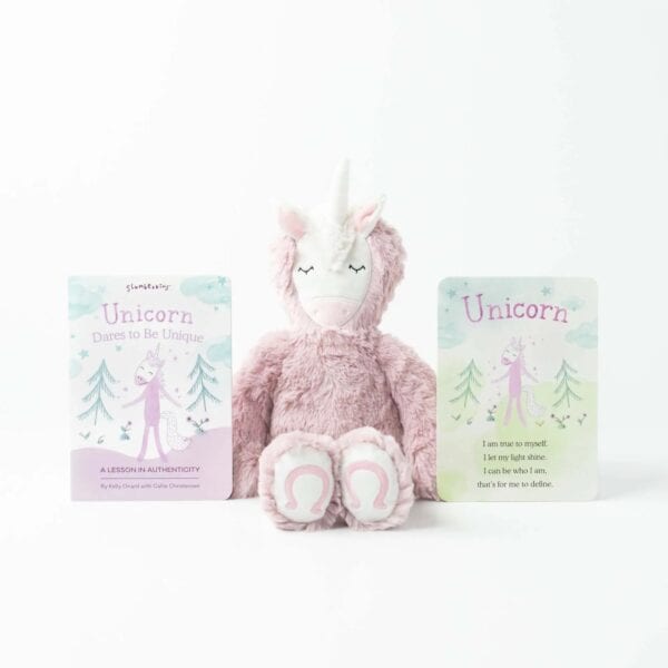 Plush unicorn with 'Dares to Be Unique' book.