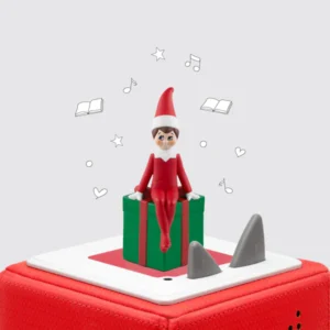 Elf toy on a red speaker with decorations.