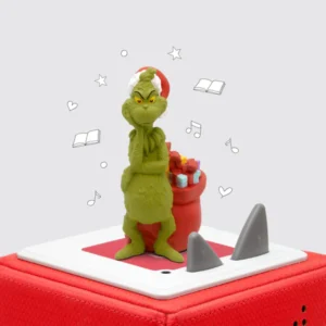 Grinch figure with Santa hat on red platform.