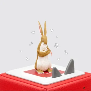 Rabbit figurine on red music box with notes.
