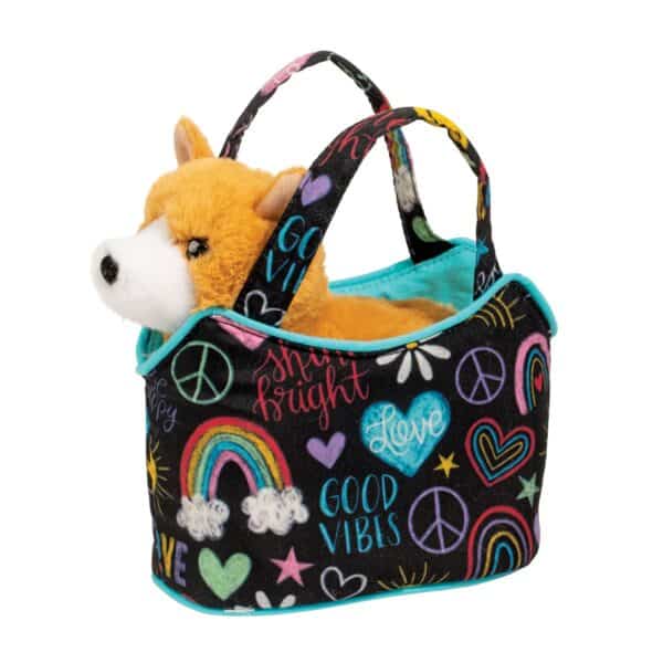 Plush dog in colorful patterned bag