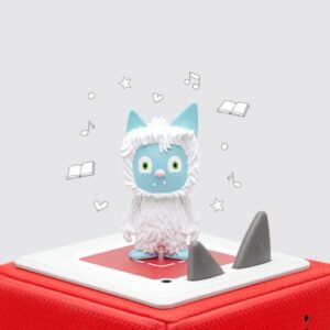 Cute monster figurine on red cube with music notes.