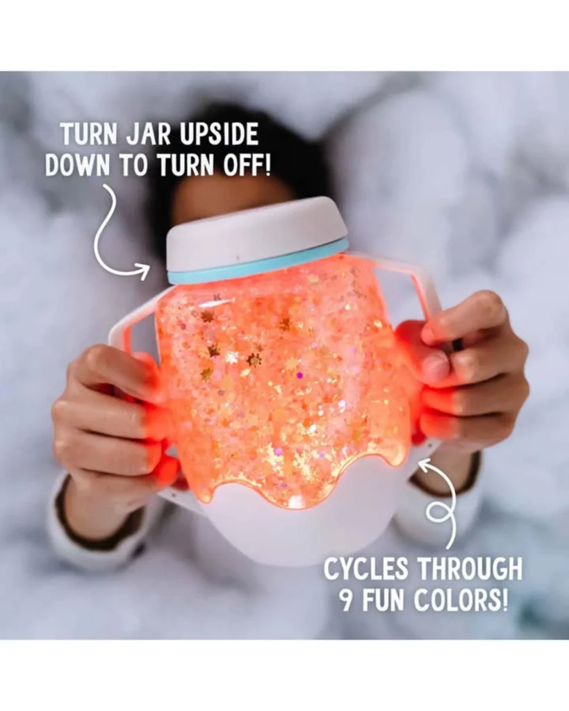 Glowing jar cycling through colors held by hands