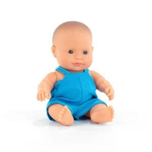 Baby doll in blue outfit sitting