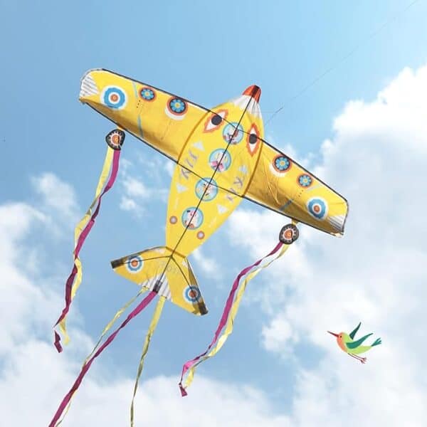 Colorful airplane kite flying in blue sky