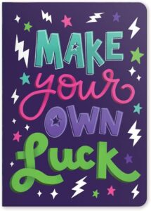 Notebook cover saying 'Make Your Own Luck'