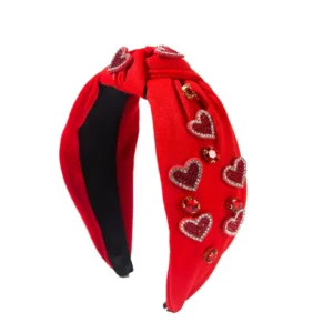 Red headband with decorative heart embellishments.