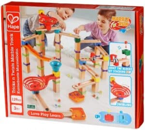 Kids playing with marble track construction toy set.