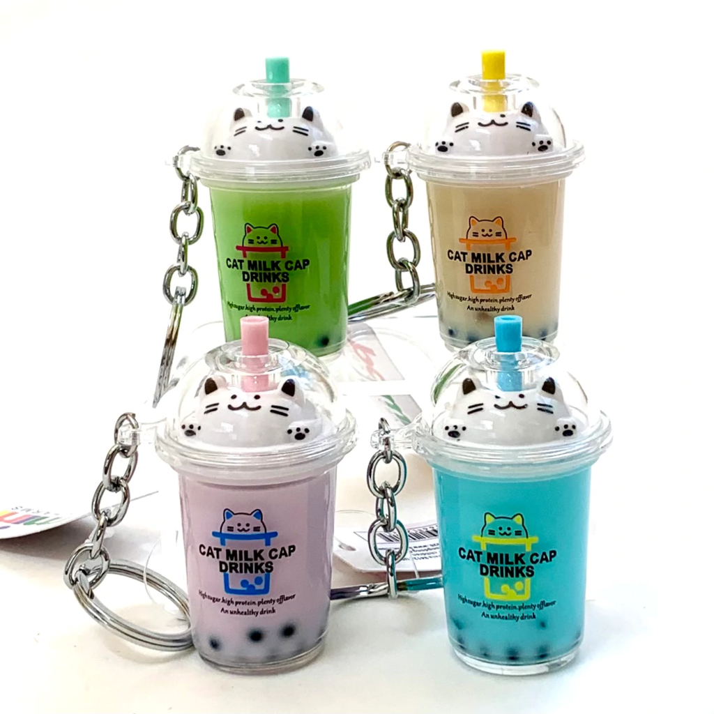 Cat-themed milk drink keychains in assorted colors.