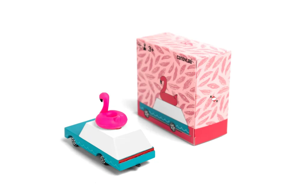 Toy car with pink flamingo on roof, packaging visible.