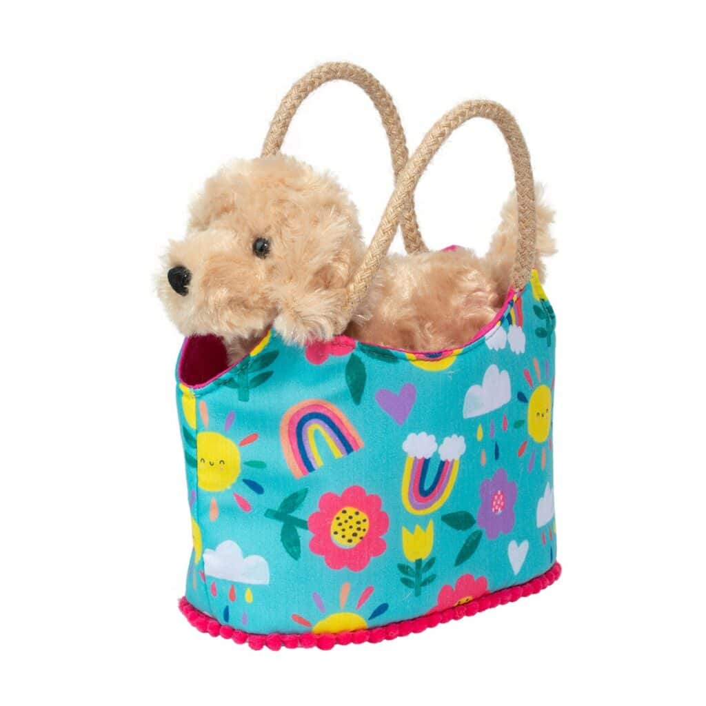 Stuffed dog in colorful floral pet carrier.