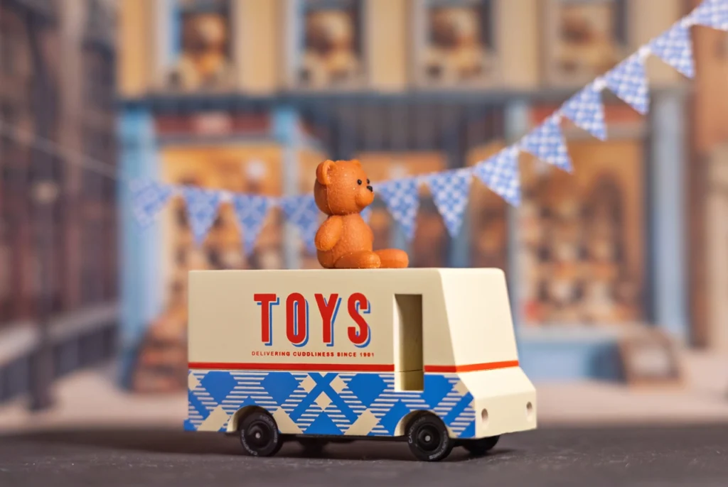 Toy truck with teddy bear on top