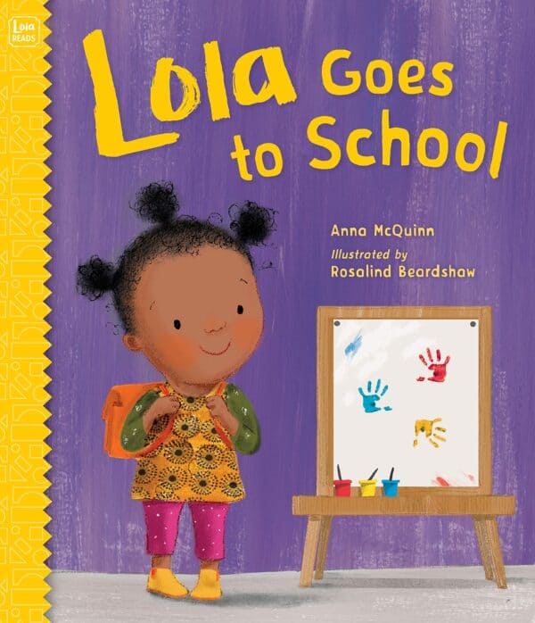 Child with backpack near colorful handprints easel.