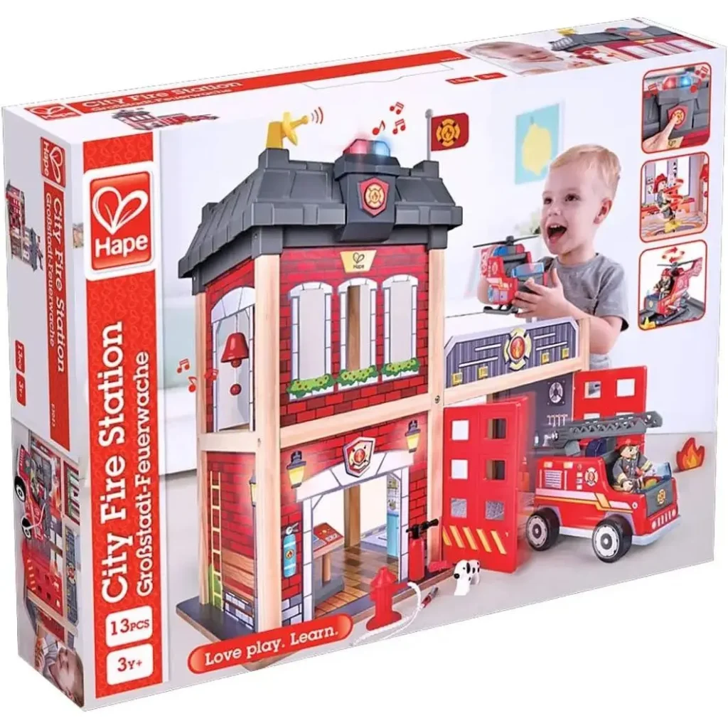 Hape toy fire station set with accessories and child.