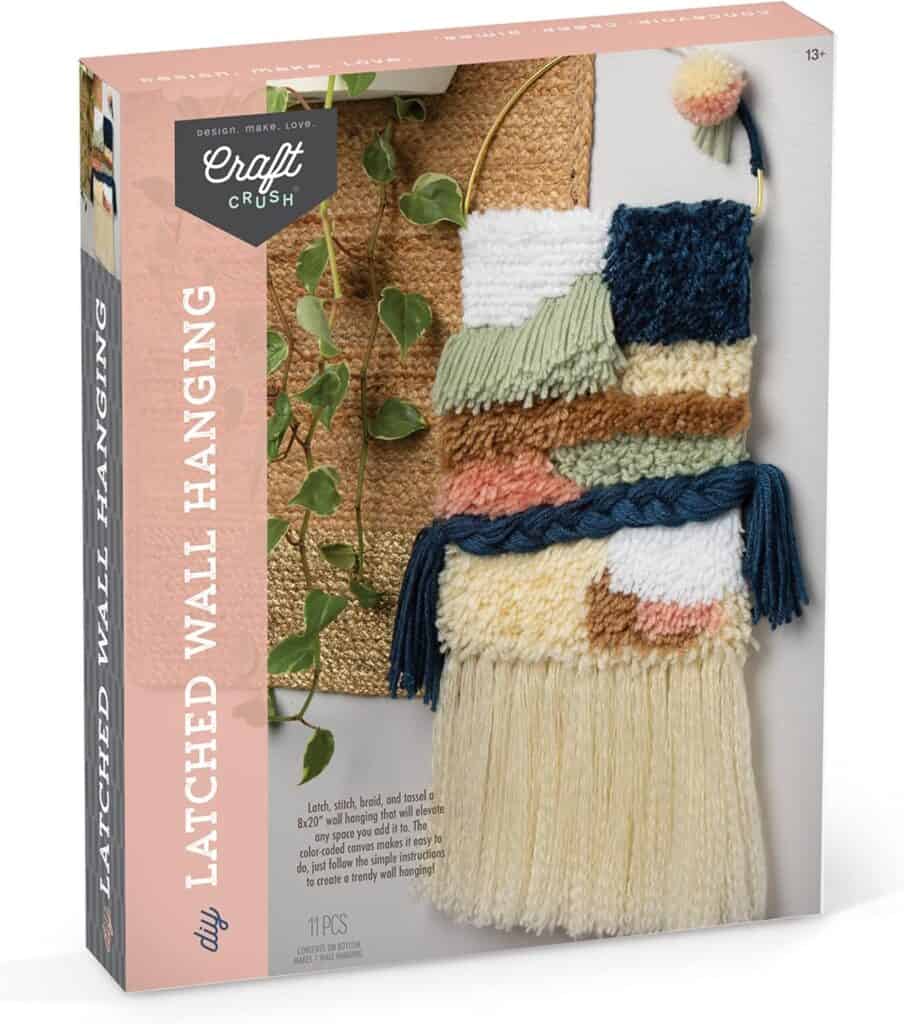 DIY latched wall hanging kit with colorful yarns.
