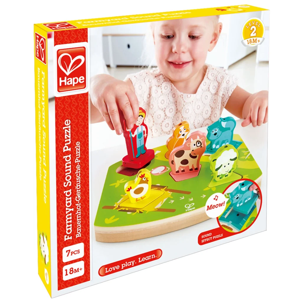 Child playing with Hape Farmyard Sound Puzzle.
