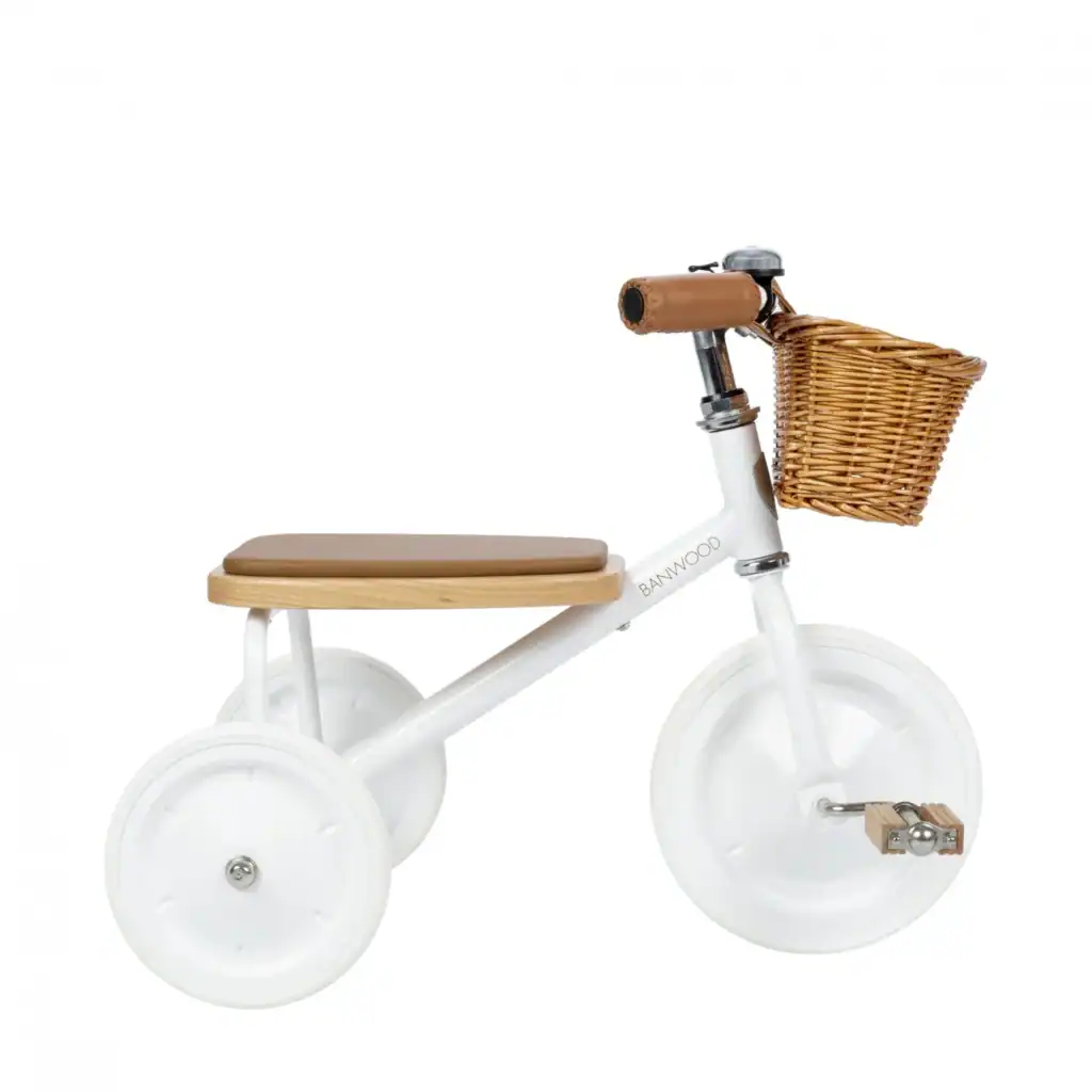 White tricycle with wicker basket for kids.