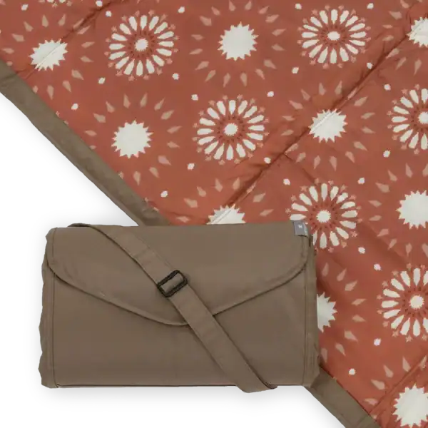 Foldable picnic blanket with floral pattern design.