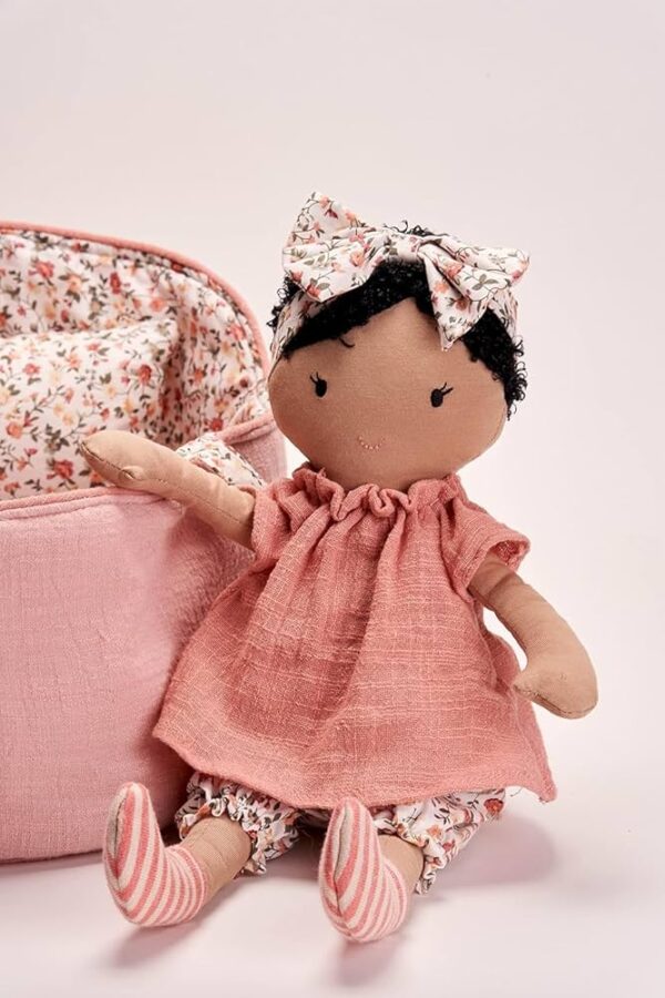 Pink cloth doll with floral bow and basket.