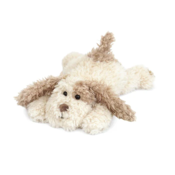 Fluffy stuffed puppy toy lying on the floor.