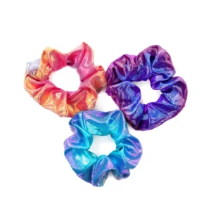 Three colorful satin scrunchies on white background.