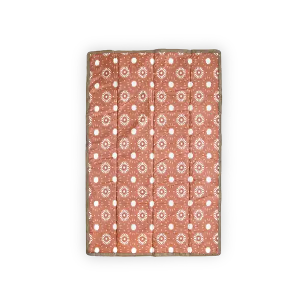 Orange blanket with white circular patterns