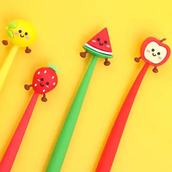 Colorful fruit-themed pens on yellow background