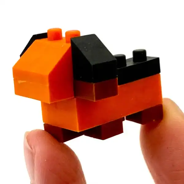 Orange and black toy dog made from building blocks