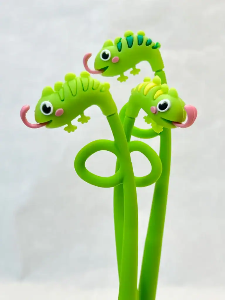 Green chameleon-shaped pens with looped bodies.