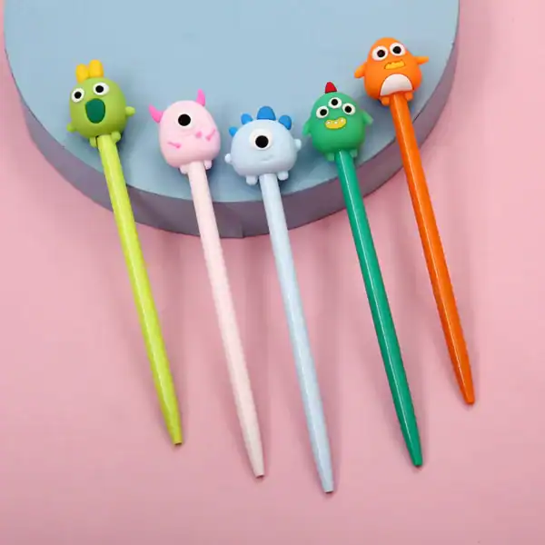 Colorful pens with cute monster toppers on display.