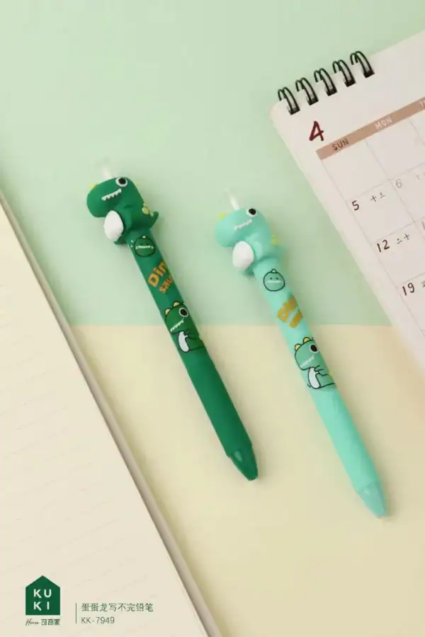 Dinosaur pens on desk with open notebook and calendar.