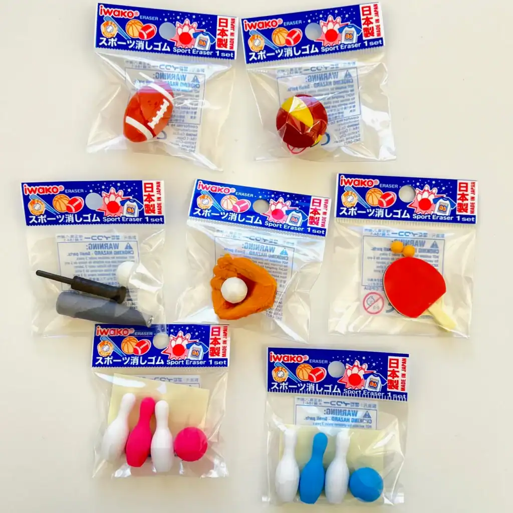 Assorted sports-themed erasers in packaging.