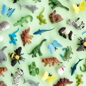 Colorful animal toys on green background